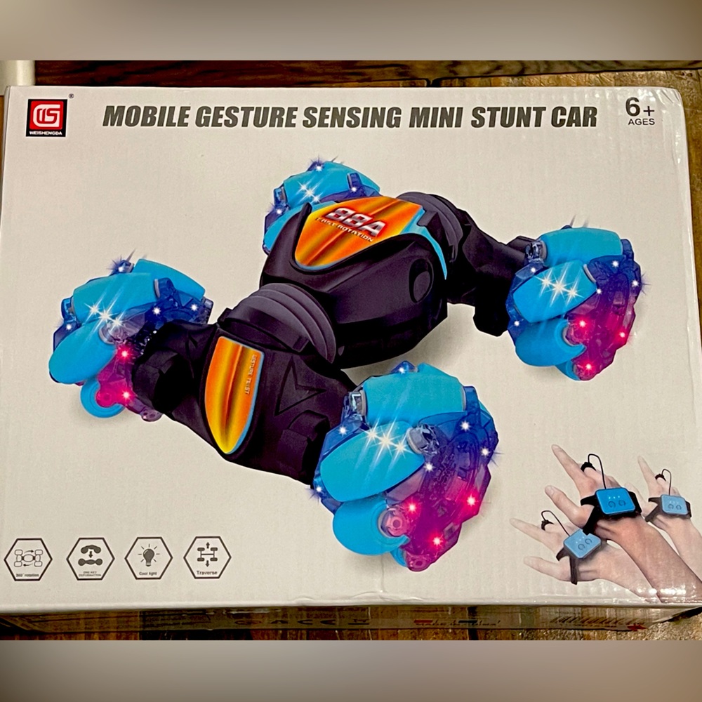 New in box. Never been opened. Mobile gesture sensing mini stunt car. Ages 6+